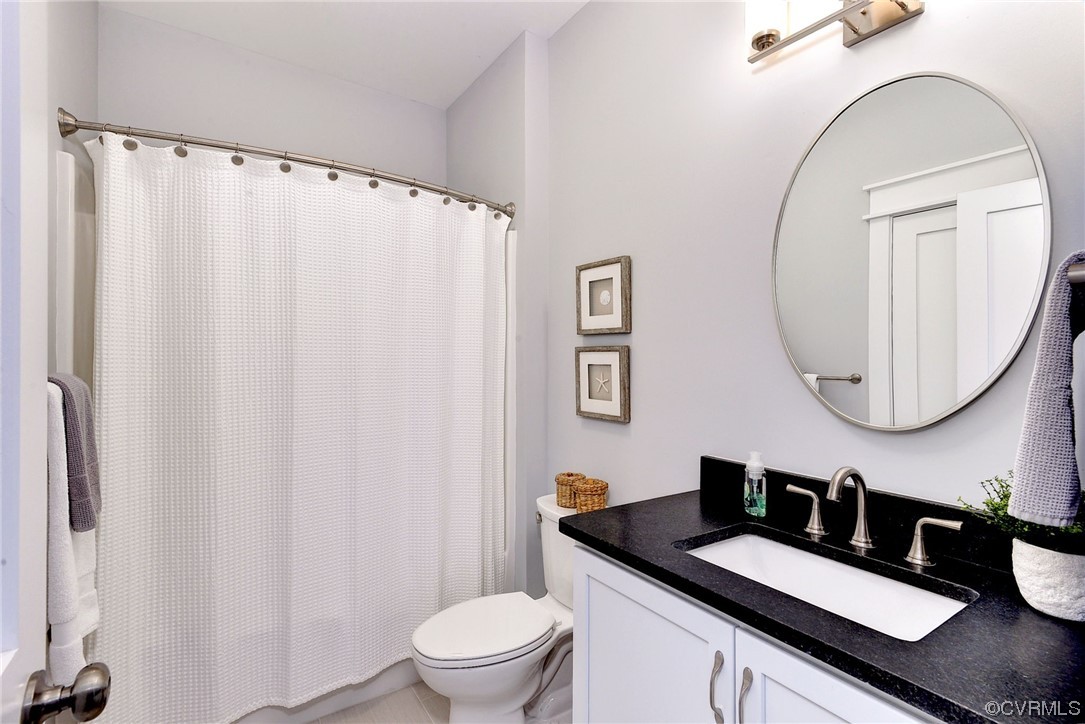 178 Old Course Loop Cape Charles, VA 23310 - Photo 28 of 49 a bathroom with a granite countertop sink toilet and a mirror