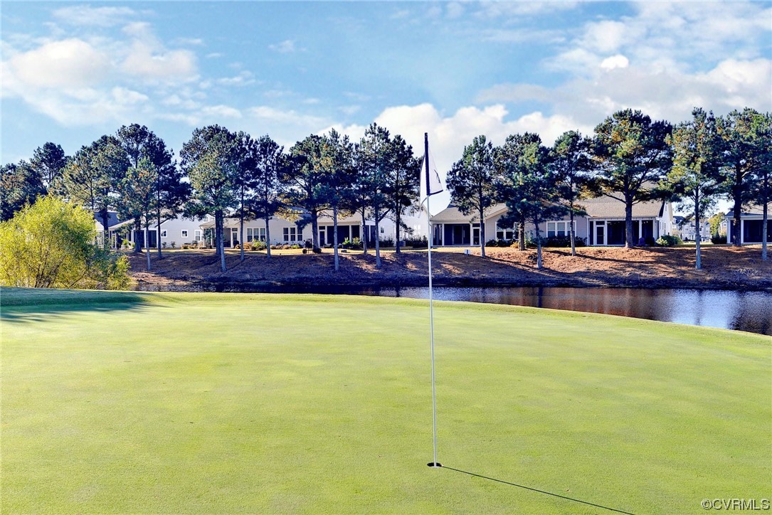 178 Old Course Loop Cape Charles, VA 23310 - Photo 43 of 49 a swimming pool that has lawn chairs and a dining table under an umbrella