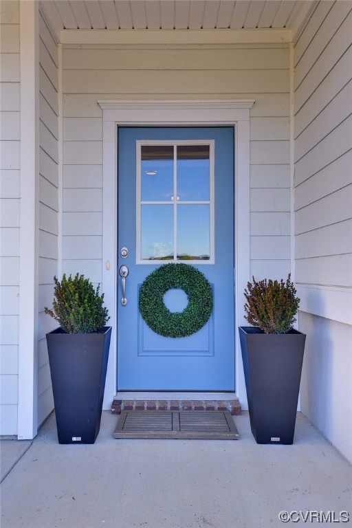 178 Old Course Loop Cape Charles, VA 23310 - Photo 5 of 49 a view of a entryway door and potted plant