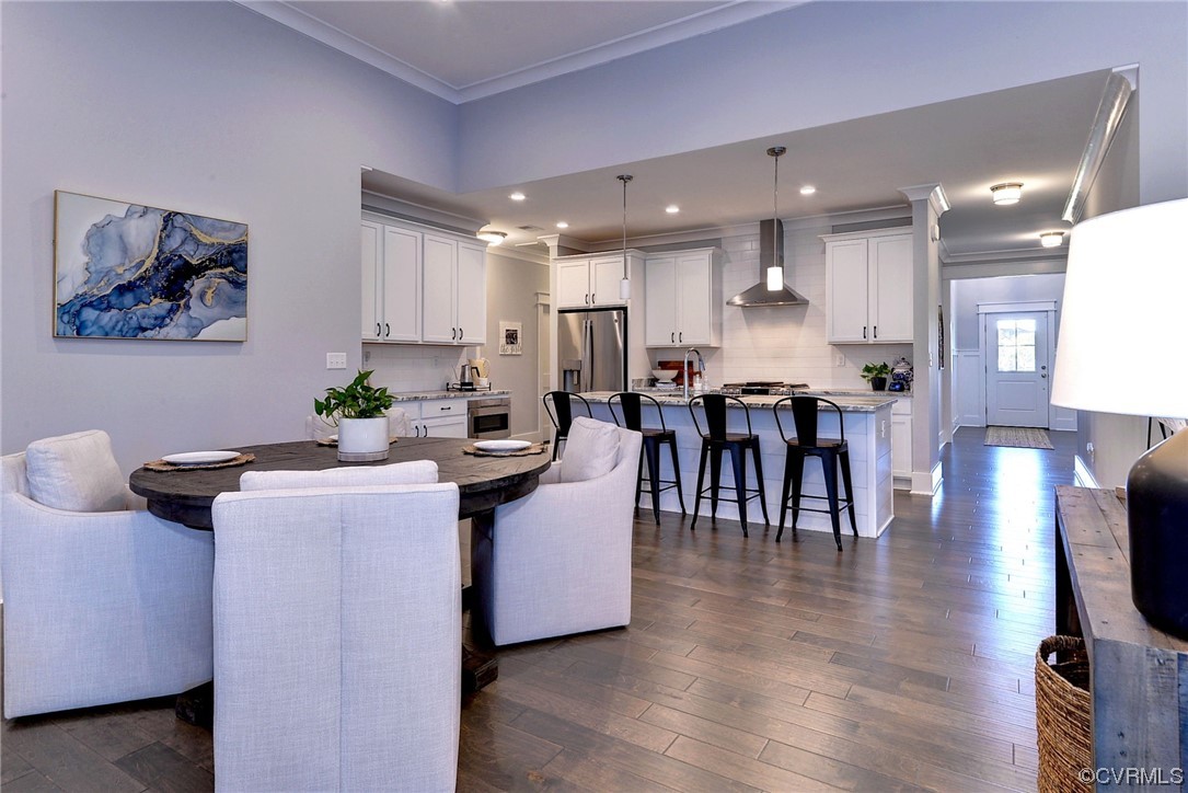 178 Old Course Loop Cape Charles, VA 23310 - Photo 8 of 49 a dining hall with stainless steel appliances kitchen island granite countertop a dining table chairs and view living room