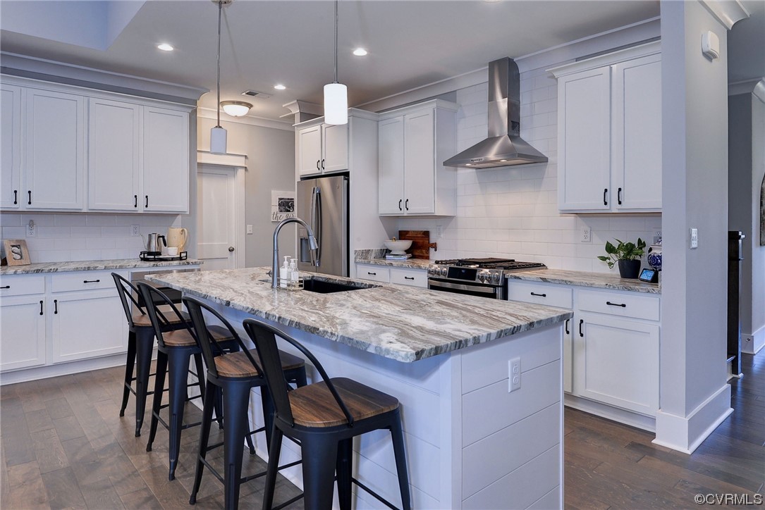 178 Old Course Loop Cape Charles, VA 23310 - Photo 9 of 49 a kitchen with stainless steel appliances granite countertop a table chairs sink and cabinets