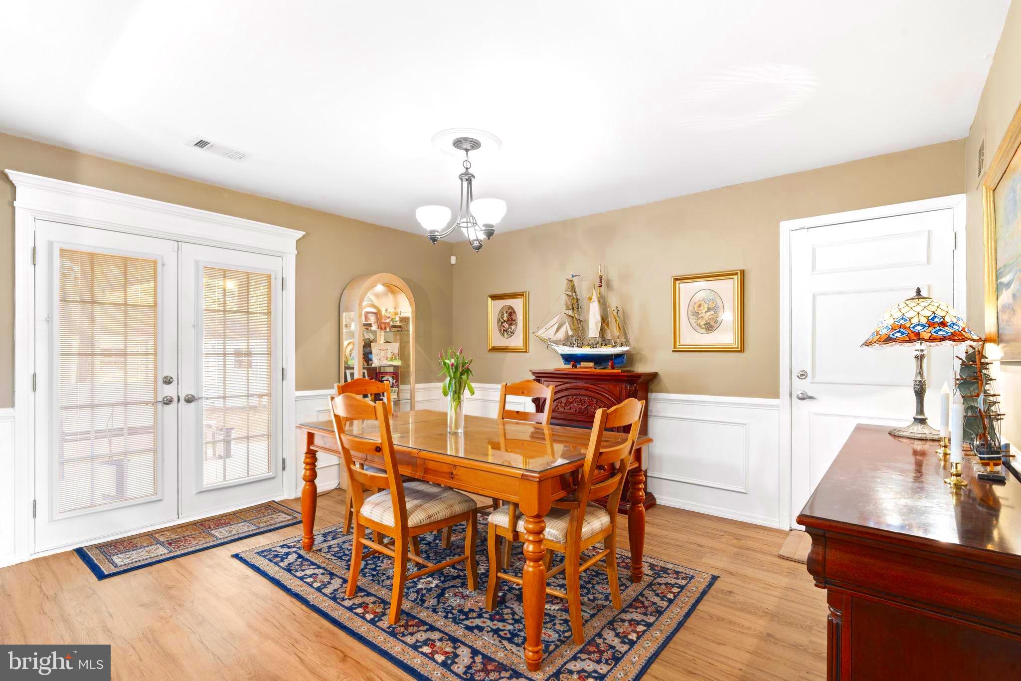 78 Lupus Lane Sewell, NJ 08080 - Photo 14 of 45 a view of a dining room with furniture a chandelier and wooden floor