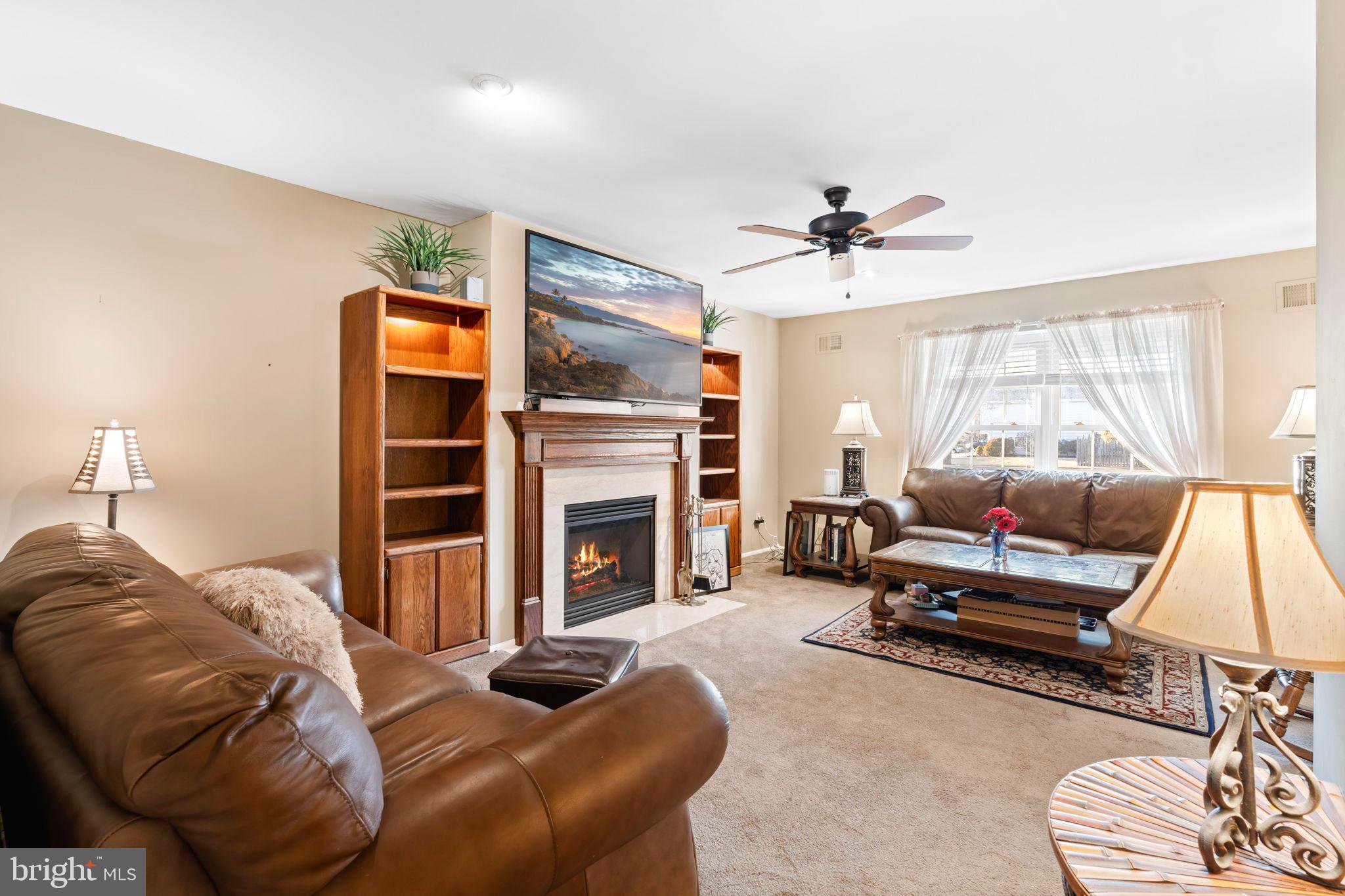 78 Lupus Lane Sewell, NJ 08080 - Photo 5 of 45 a living room with furniture a fireplace and a flat screen tv