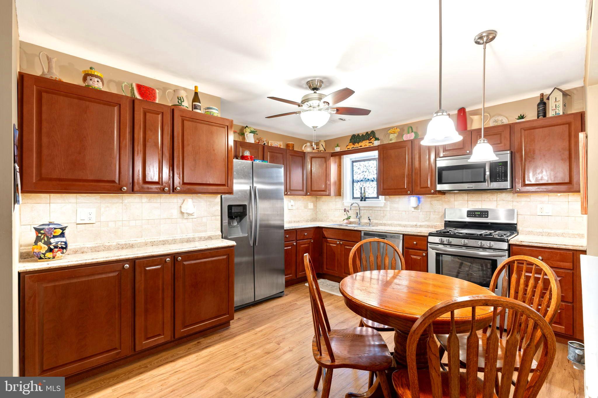 78 Lupus Lane Sewell, NJ 08080 - Photo 10 of 45 a kitchen with stainless steel appliances granite countertop a sink and wooden cabinets