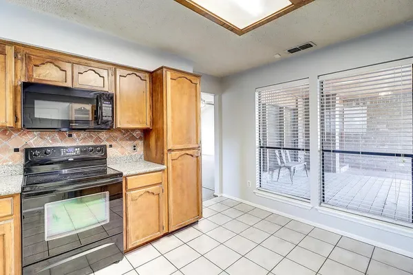 a kitchen with stainless steel appliances a stove sink and microwave