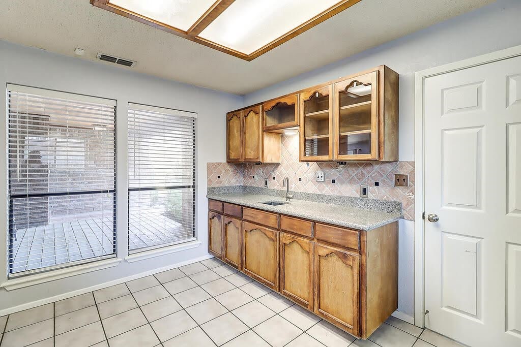 7034 Powderhorn Court Corpus Christi, TX 78413 - Photo 12 of 38 a spacious bathroom with a granite countertop sink a mirror and a shower