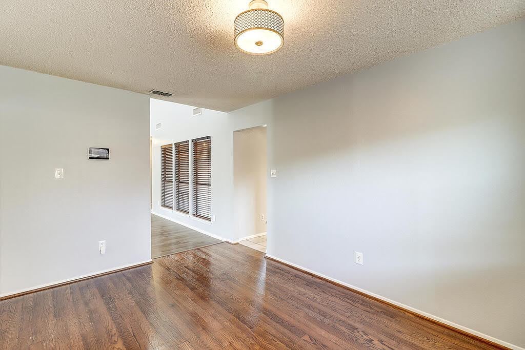 7034 Powderhorn Court Corpus Christi, TX 78413 - Photo 15 of 38 a view of an empty room with wooden floor and a window