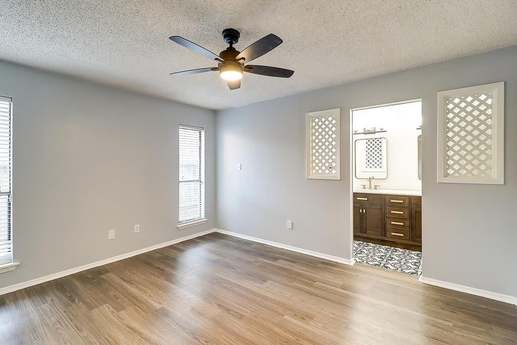 7034 Powderhorn Court Corpus Christi, TX 78413 - Photo 18 of 38 an empty room with wooden floor and windows
