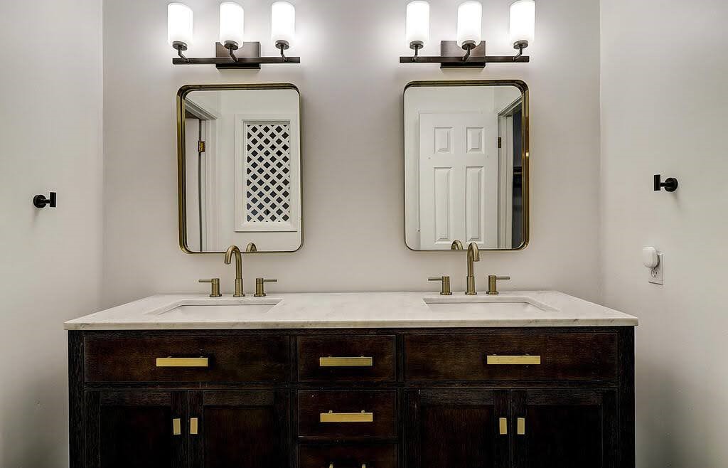 7034 Powderhorn Court Corpus Christi, TX 78413 - Photo 22 of 38 a bathroom with double vanity sinks and a mirror