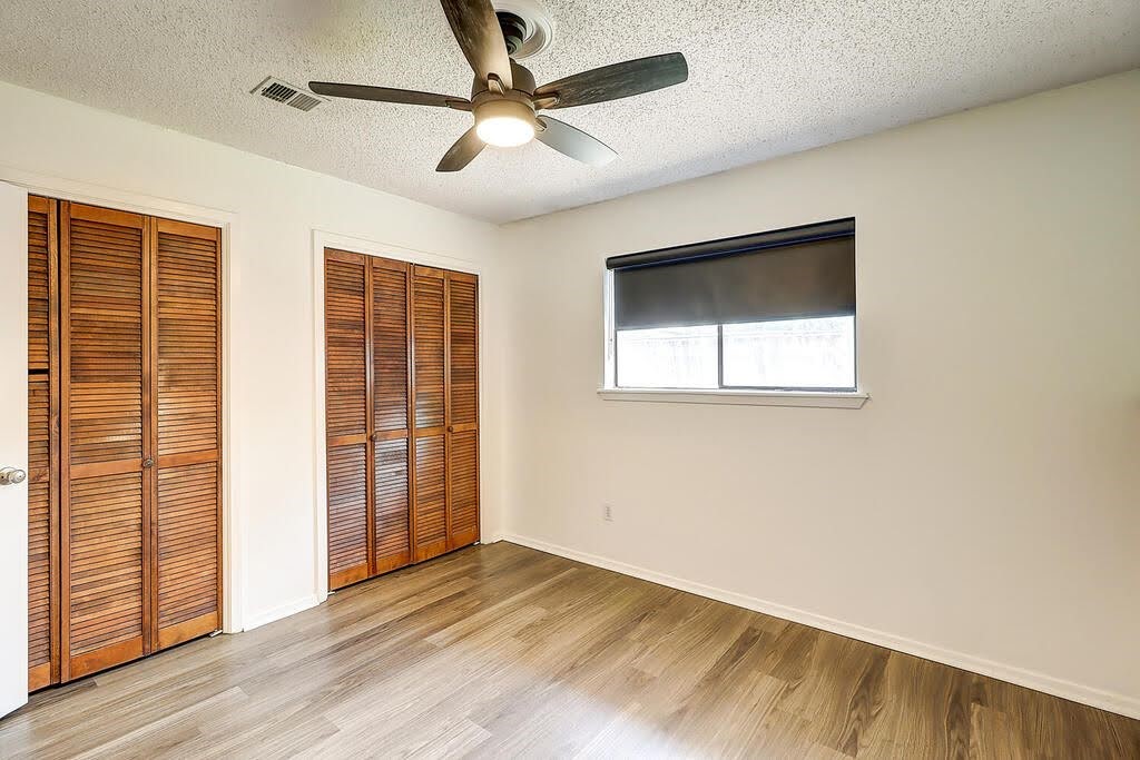 7034 Powderhorn Court Corpus Christi, TX 78413 - Photo 28 of 38 an empty room with wooden floor fan and windows