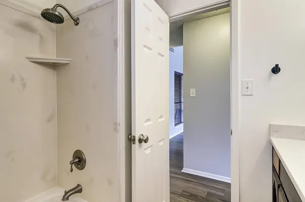 a bathroom with a glass shower door