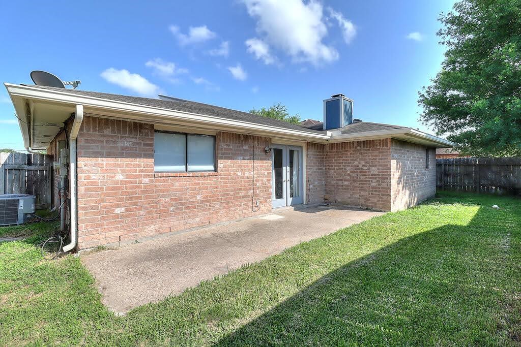 7034 Powderhorn Court Corpus Christi, TX 78413 - Photo 37 of 38 a front view of a house with a yard and garage