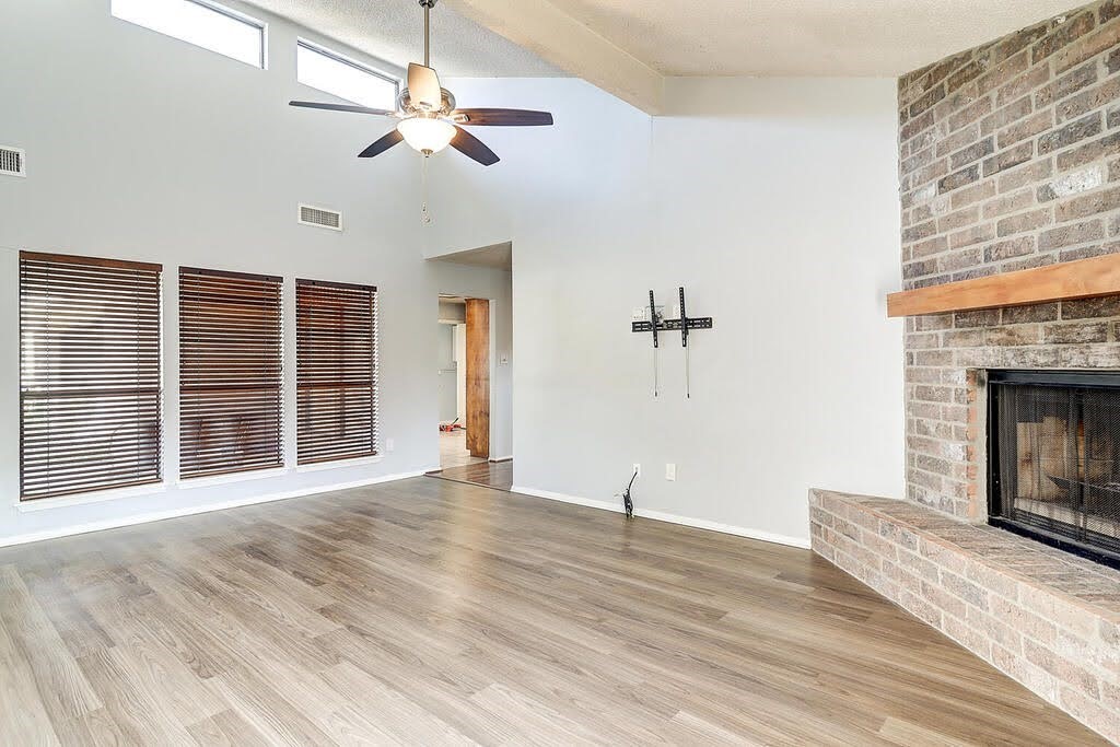 7034 Powderhorn Court Corpus Christi, TX 78413 - Photo 5 of 38 a view of an empty room with a fireplace and a window