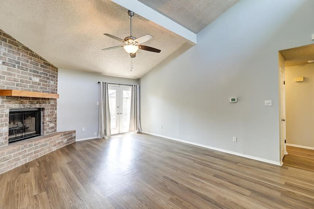 7034 Powderhorn Court Corpus Christi, TX 78413 - Photo 6 of 38 a view of an empty room with wooden floor and a fireplace