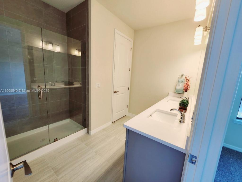 8189 Cinch Way, Unit 8189 Lake Worth, FL 33467 - Photo 5 of 11 a bathroom with a tub shower and sink