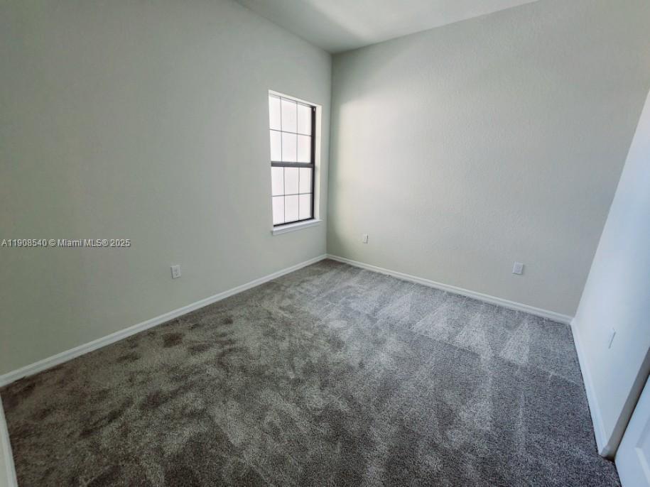 8189 Cinch Way, Unit 8189 Lake Worth, FL 33467 - Photo 9 of 11 an empty room with windows