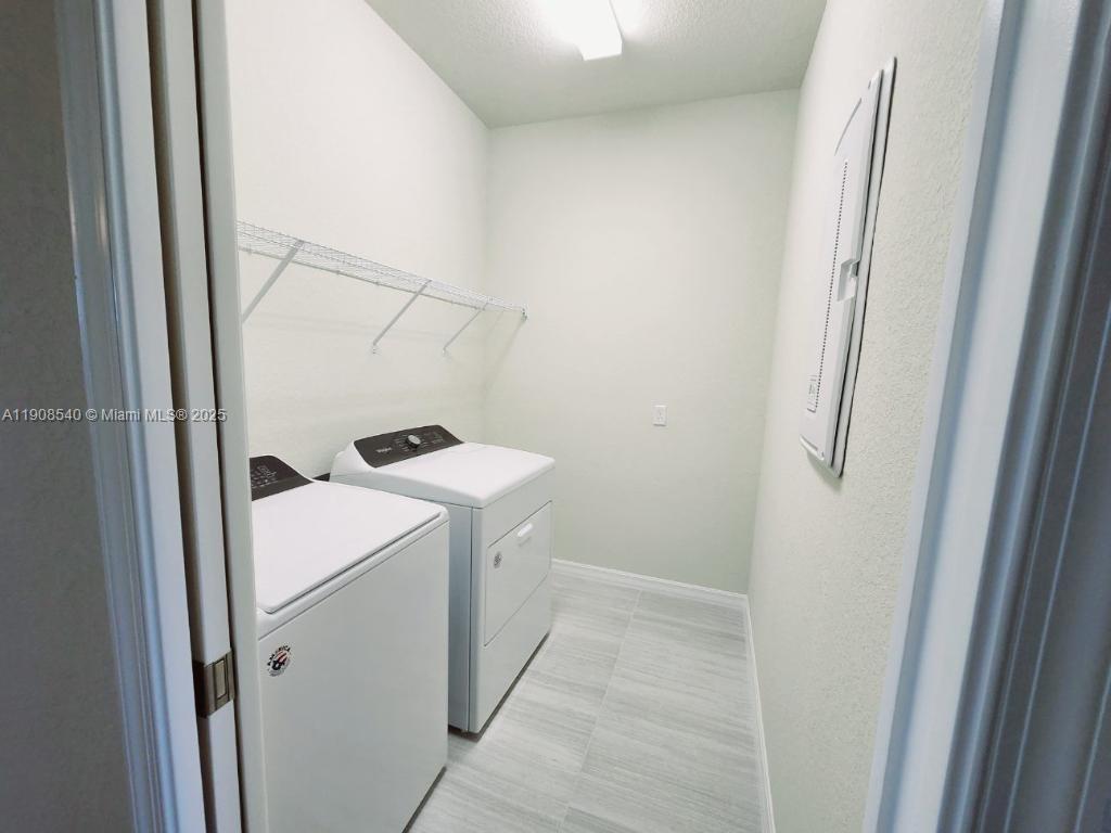 8189 Cinch Way, Unit 8189 Lake Worth, FL 33467 - Photo 10 of 11 a utility room with dryer and washer