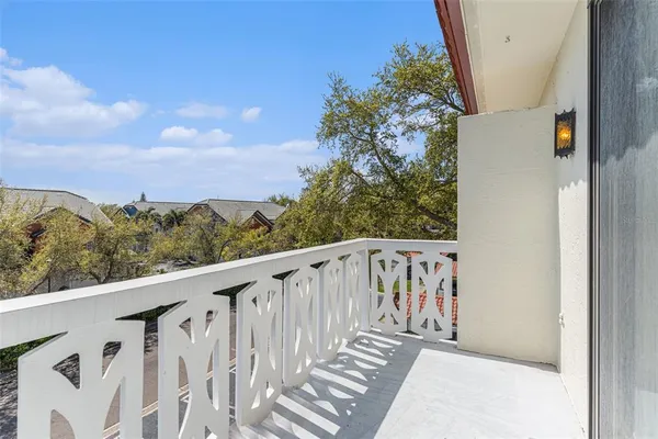 a view of a balcony with wooden fence and floor