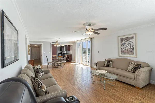 a living room with furniture and wooden floor
