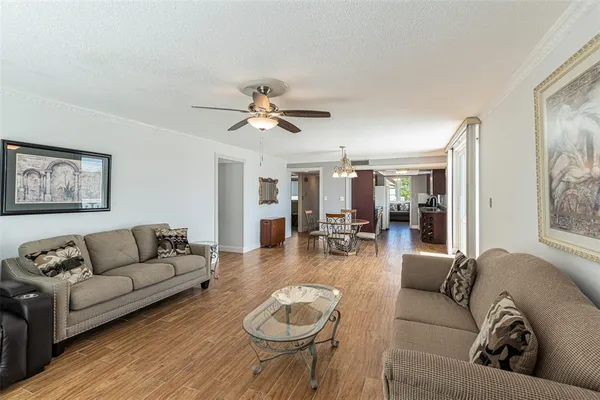 a living room with furniture and a wooden floor