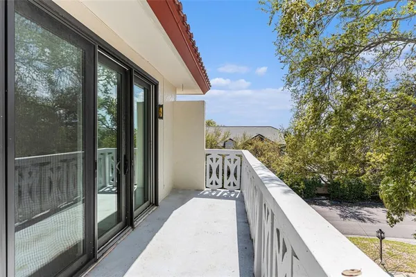 a view of a balcony with wooden fence