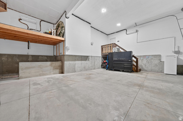 14738 Tangle Hill Road Herriman, UT 84096 - Photo 55 of 66 Spacious utility area featuring a concrete floor, exposed concrete foundation walls, and white painted upper walls