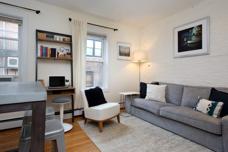 39 Gray Street, Unit 2 Boston, MA 02116 - Photo 1 of 1 a living room with furniture and a wooden floor