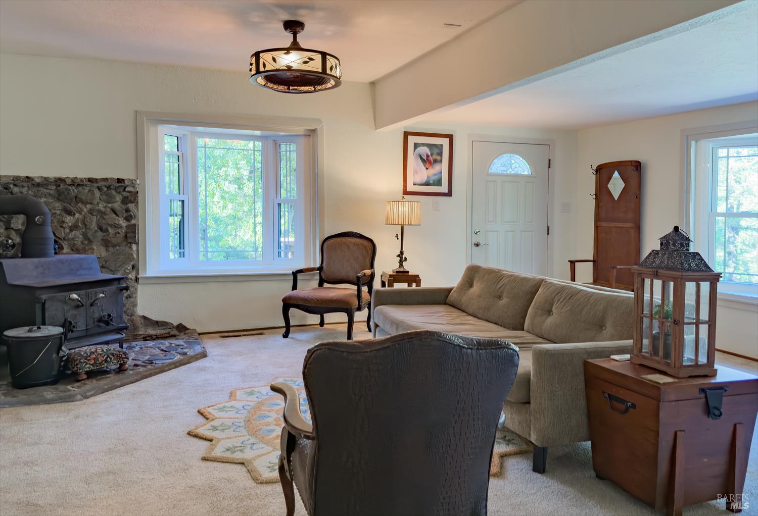 5845 Austin Creek Road Cazadero, CA 95421 - Photo 11 of 26 a living room with furniture a window and a lamp