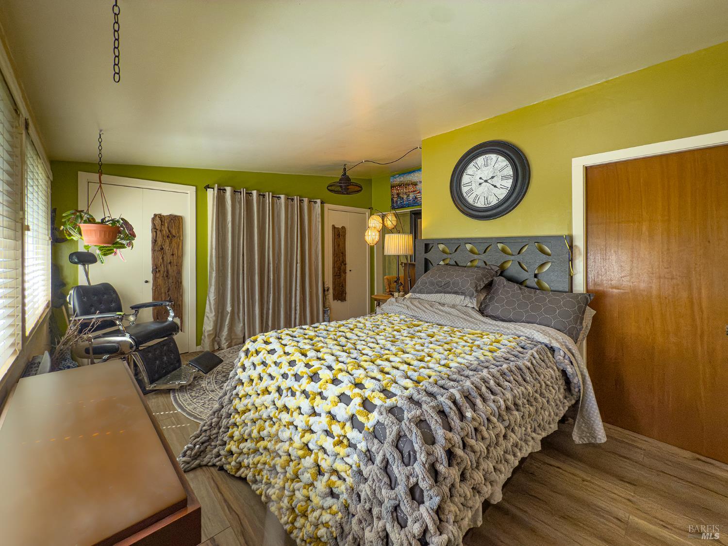 5845 Austin Creek Road Cazadero, CA 95421 - Photo 17 of 26 a bedroom with a bed and a chandelier