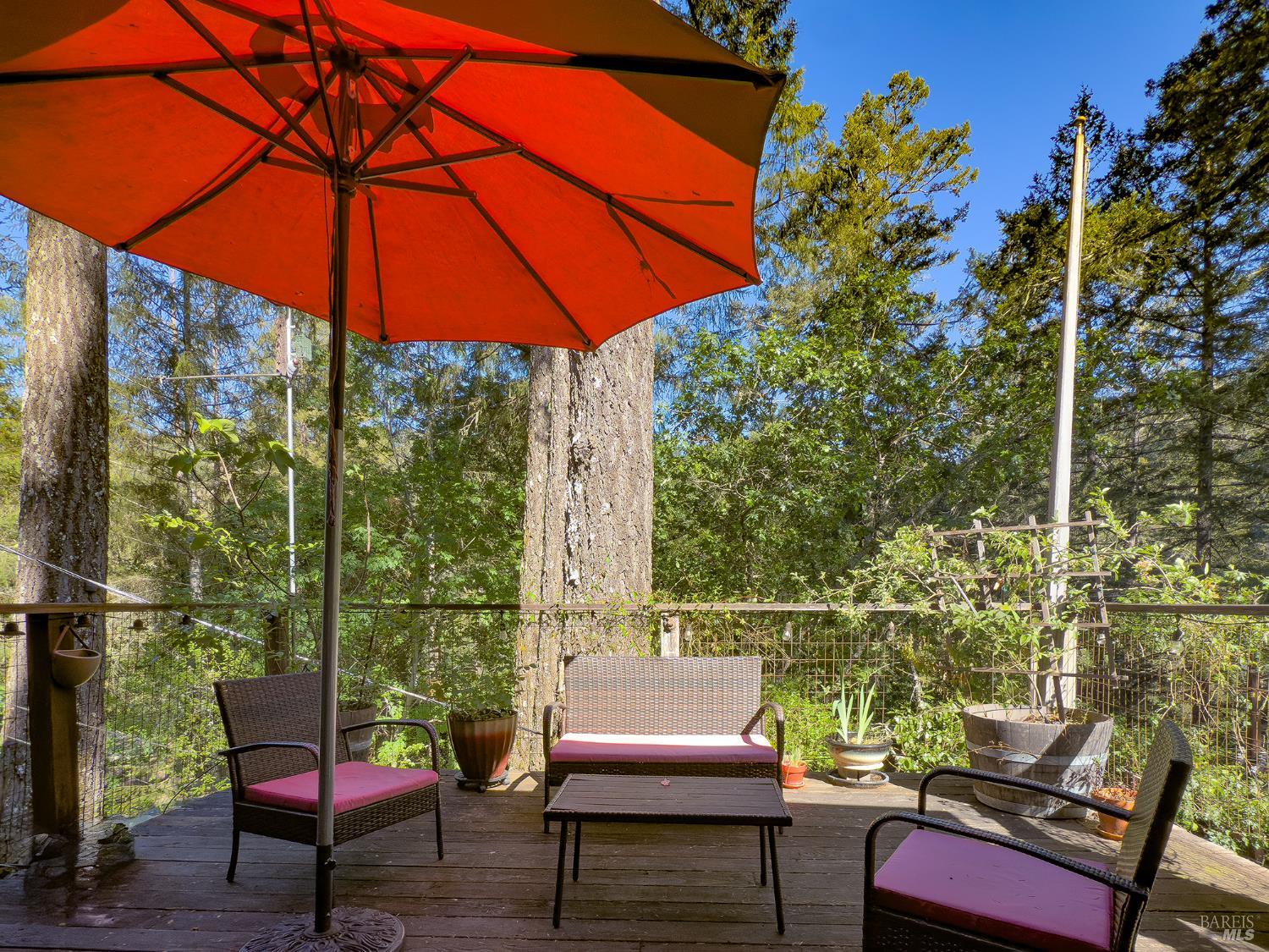 5845 Austin Creek Road Cazadero, CA 95421 - Photo 23 of 26 a view of an outdoor sitting area with furniture and umbrella