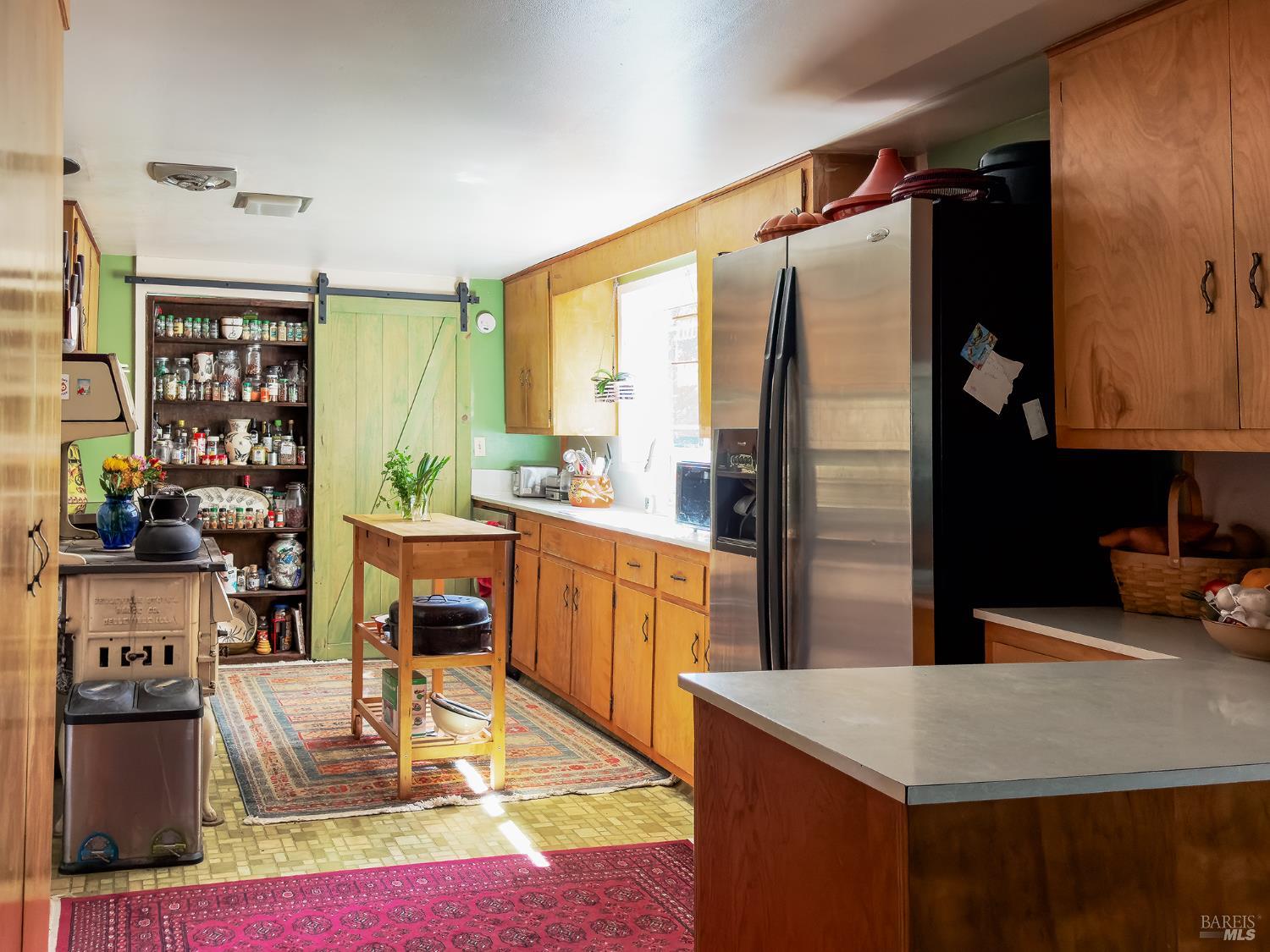 5845 Austin Creek Road Cazadero, CA 95421 - Photo 6 of 26 a kitchen with stainless steel appliances granite countertop a refrigerator and a stove top oven