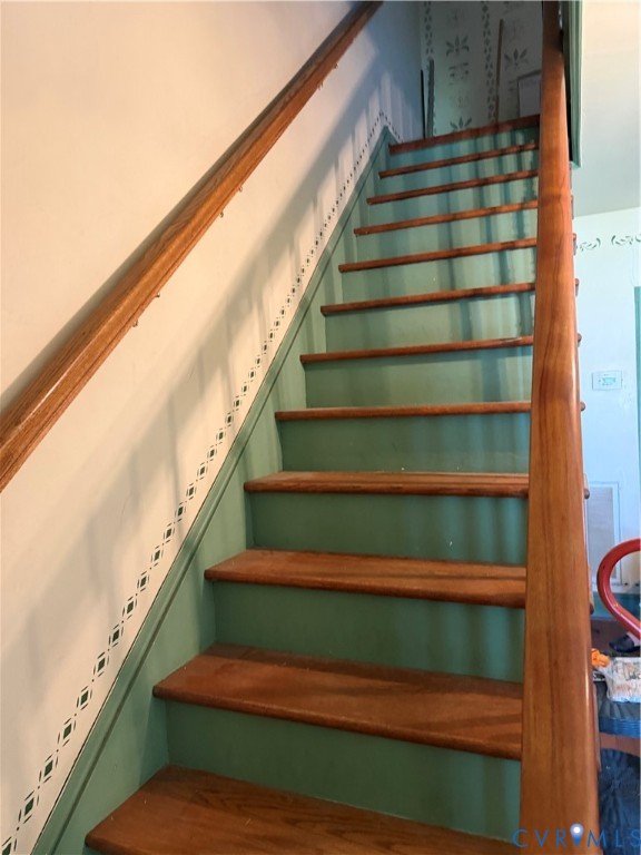 2984 Rolfe Highway Dendron, VA 23839 - Photo 11 of 15 Staircase featuring wood treads, green risers, and