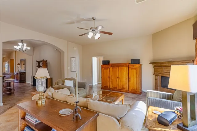 a living room with furniture and a chandelier