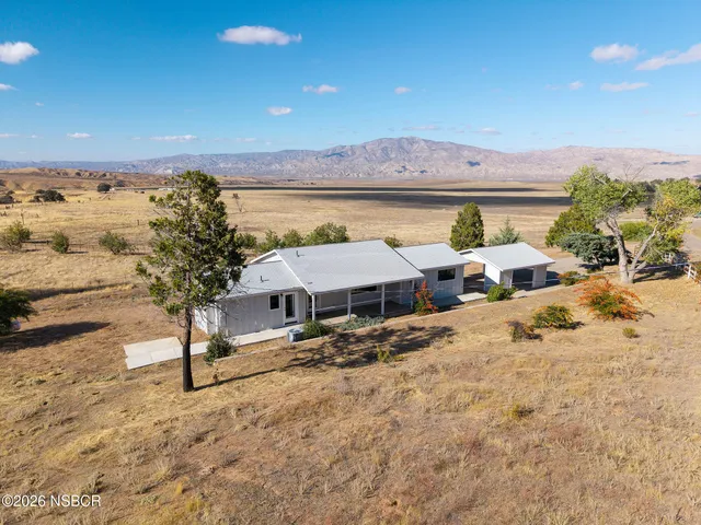a view of a house with wooden fence