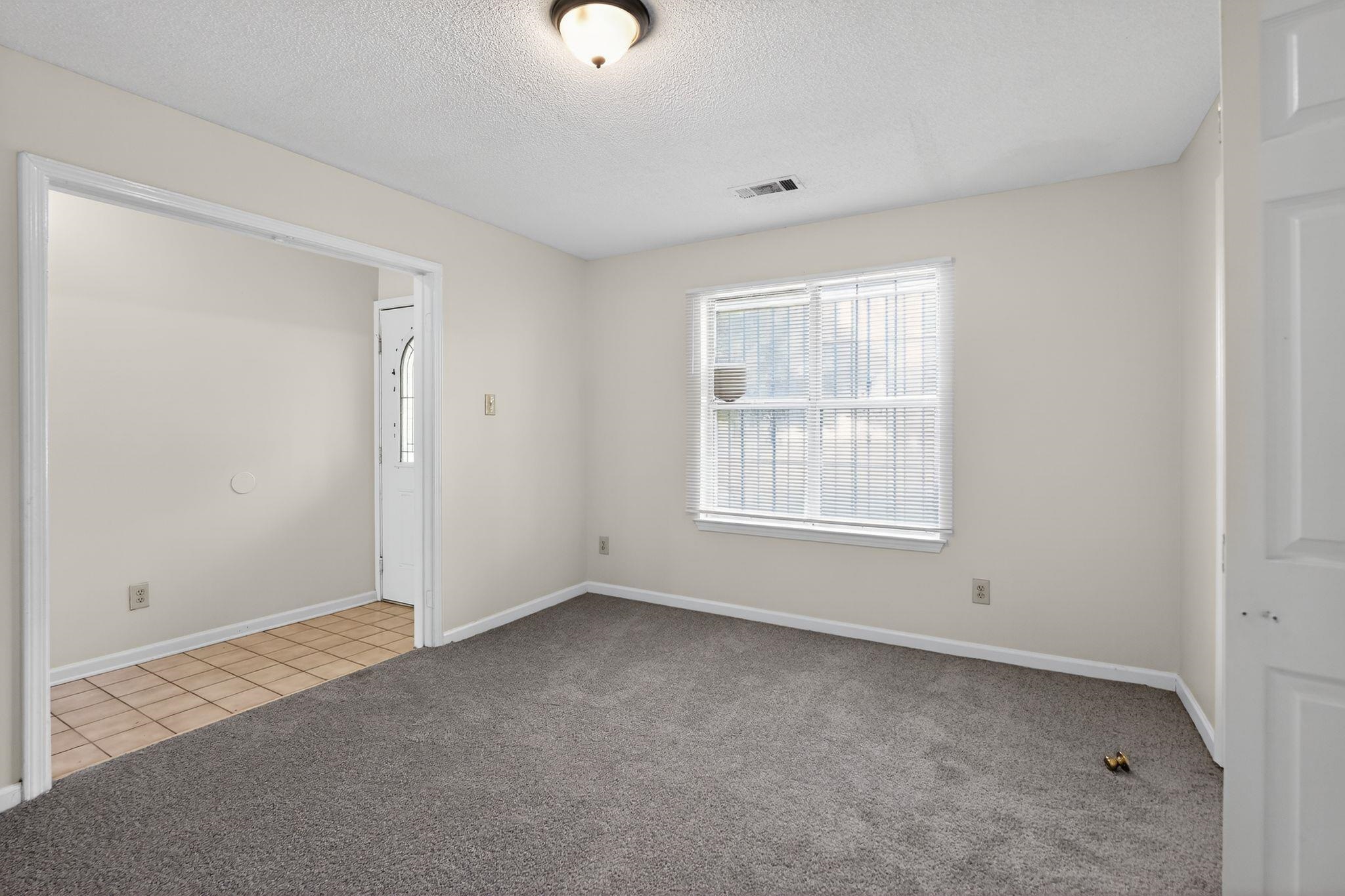 3820 Clarke Road Memphis, TN 38115 - Photo 16 of 30 Unfurnished bedroom featuring light carpet, a textured ceiling, and light tile patterned flooring