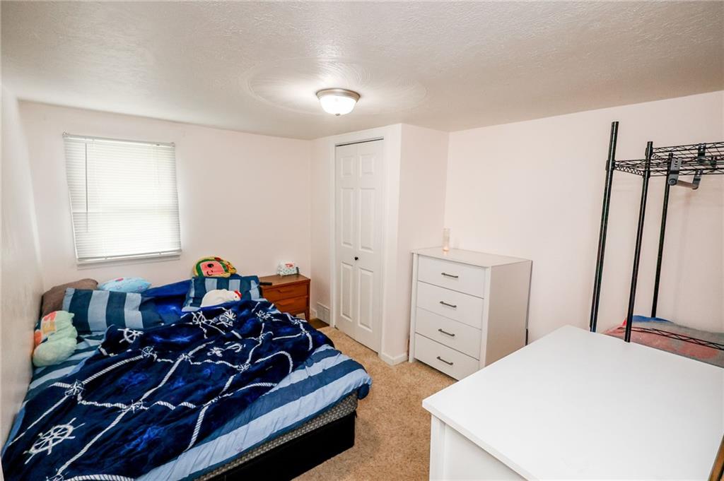 343 Whitestown Road Butler, PA 16001 - Photo 23 of 30 a bed room with a bed and a tv