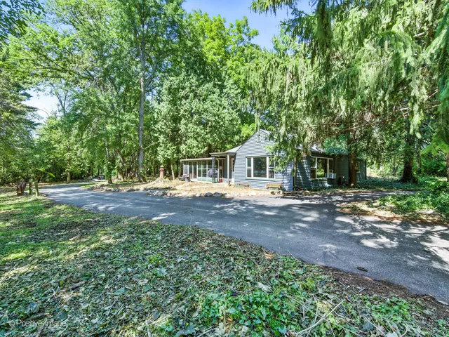 a view of backyard of house with green space