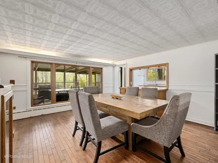 a dining room with furniture and wooden floor