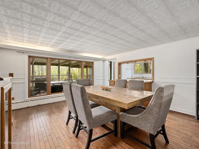 a dining room with furniture and wooden floor