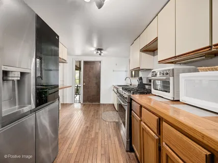 a kitchen with stainless steel appliances granite countertop a stove and a refrigerator