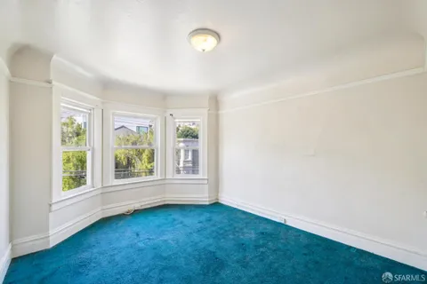 an empty room with windows and closet