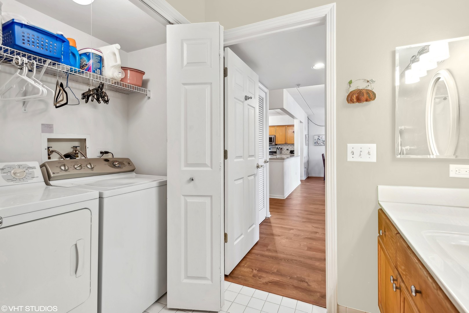 455 West Front Street, Unit 404 Wheaton, IL 60187 - Photo 12 of 16 a hallway with white cabinets and wooden floor
