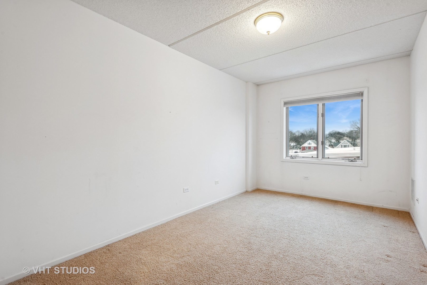455 West Front Street, Unit 404 Wheaton, IL 60187 - Photo 13 of 16 an empty room with windows