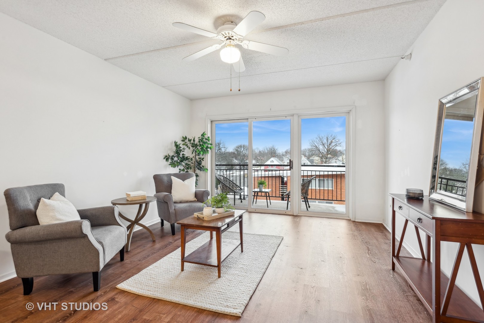 455 West Front Street, Unit 404 Wheaton, IL 60187 - Photo 7 of 16 a living room with furniture a chandelier and a table
