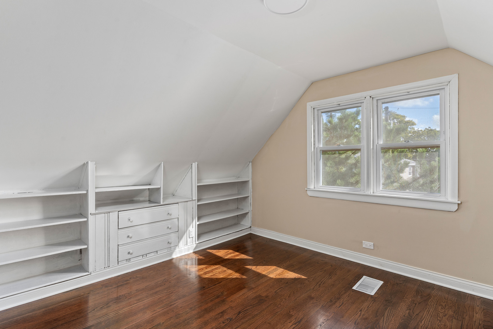 5345 North Neva Avenue Chicago, IL 60656 - Photo 18 of 32 a view of an empty room with a window and wooden floor