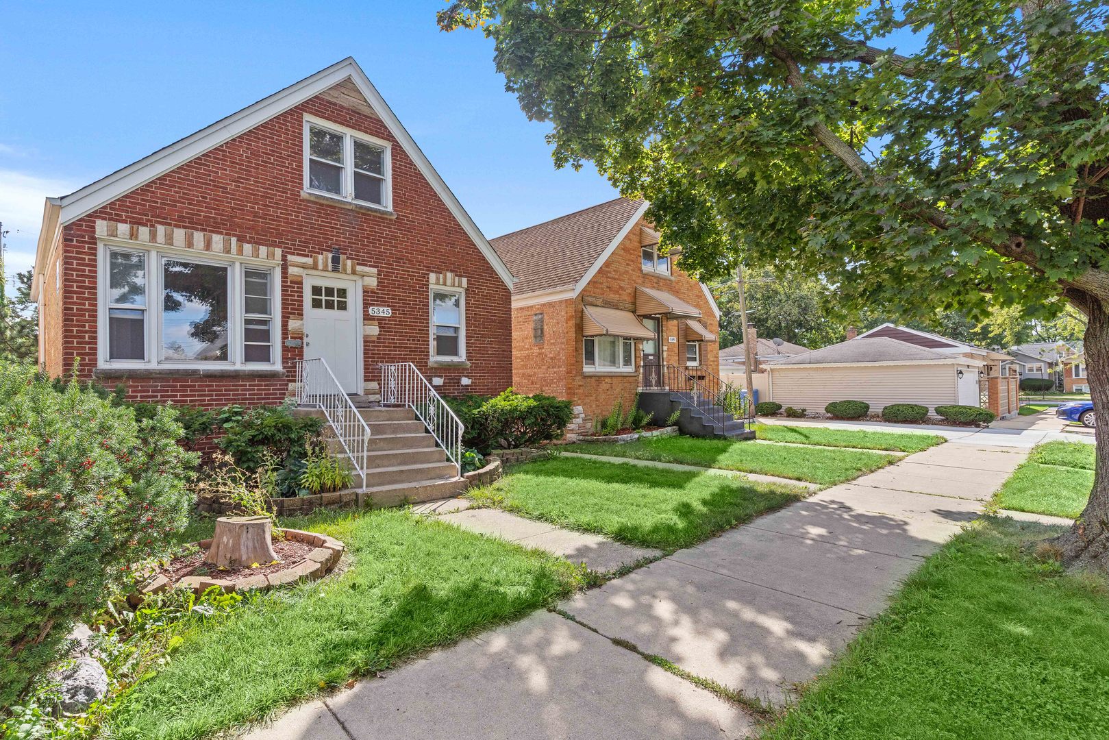 5345 North Neva Avenue Chicago, IL 60656 - Photo 3 of 32 a front view of a house with a yard and potted plants