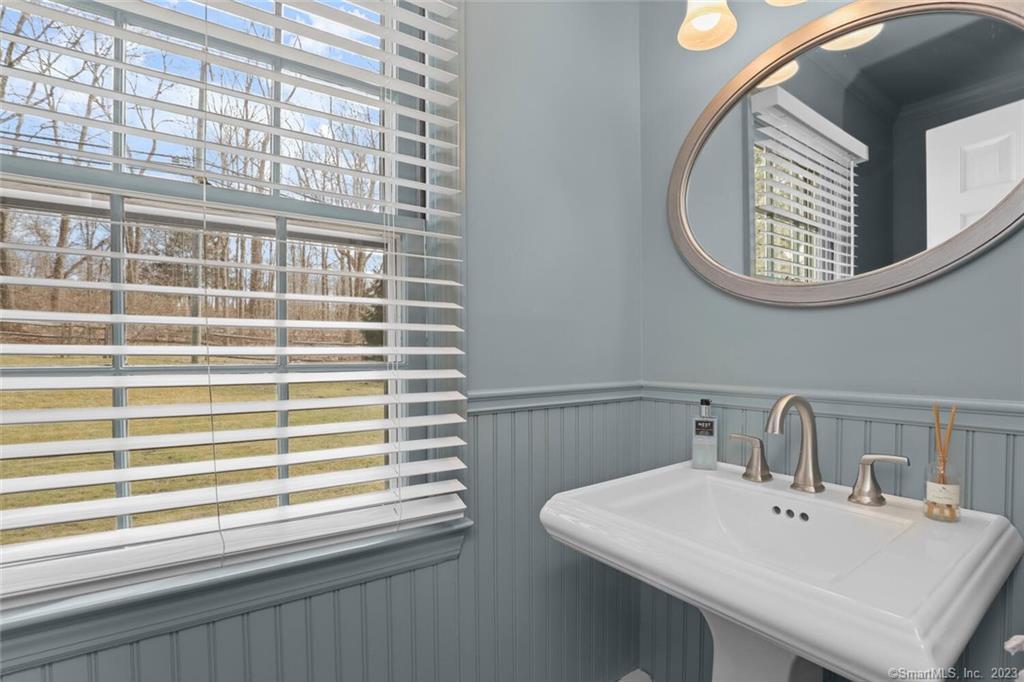 183 Frogtown Road New Canaan, CT 06840 - Photo 14 of 37 a bathroom with a sink and a mirror