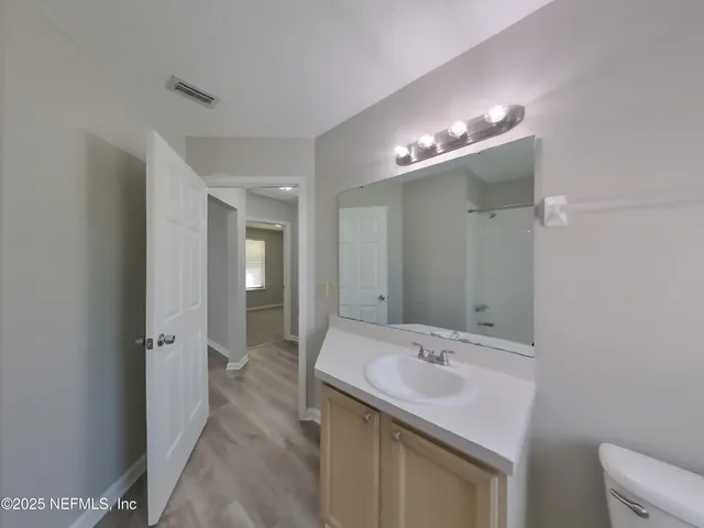 a bathroom with a sink double vanity and a mirror