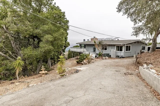 a view of a house with yard and sitting area