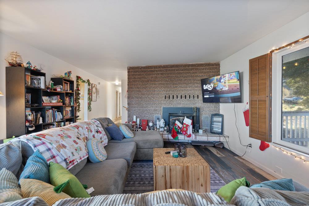 380 Hillside Road San Juan Bautista, CA 95045 - Photo 21 of 60 a living room with furniture and a fireplace